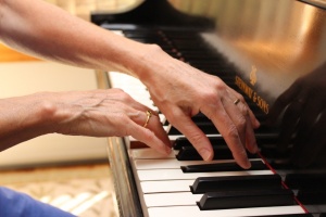 Photo of hands playing a piano